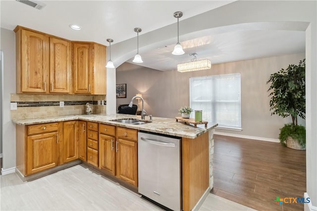2652 Poplar Grove Ln, Schertz, TX 78154 - kitchen with dishwasher, a peninsula, light wood-style floors, light stone countertops, and tasteful backsplash