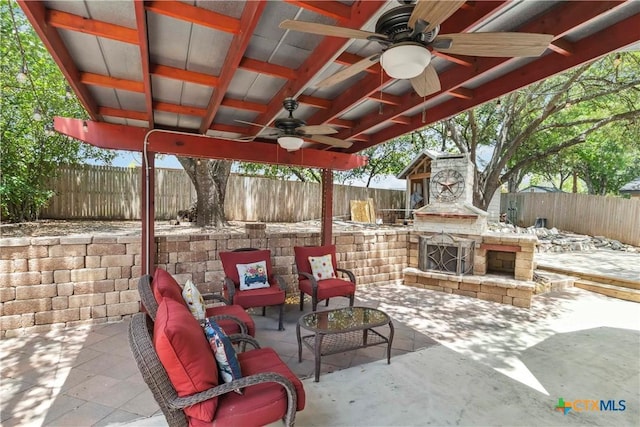 2652 Poplar Grove Ln, Schertz, TX 78154 - fenced backyard featuring an outdoor stone fireplace, a ceiling fan, and a patio area