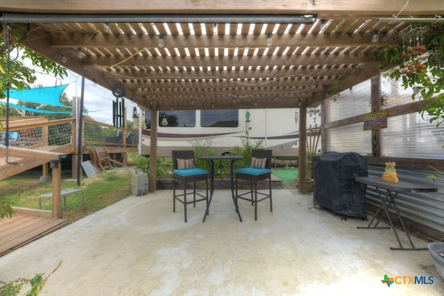 view of patio / terrace with area for grilling and a pergola