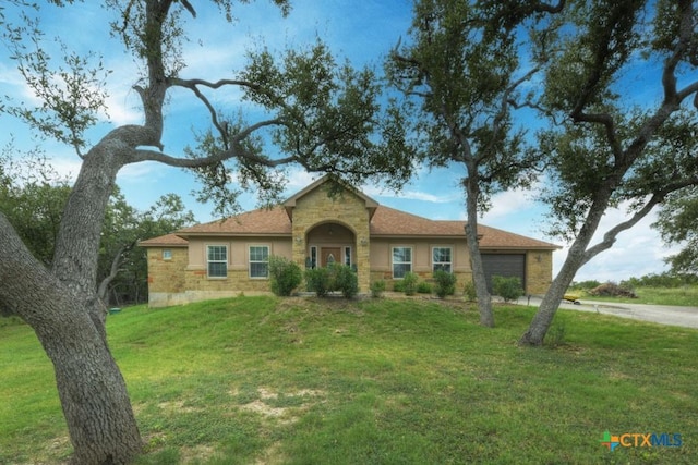 861 Rutherford, Fischer, TX 78623 - view of front facade with an attached garage, stone siding, a front yard, stucco siding, and driveway