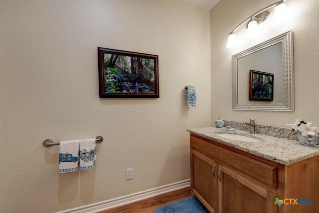 bathroom featuring hardwood / wood-style floors and vanity