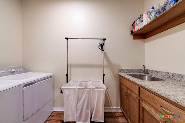861 Rutherford, Fischer, TX 78623 - clothes washing area with washer and dryer, a sink, baseboards, and dark wood finished floors