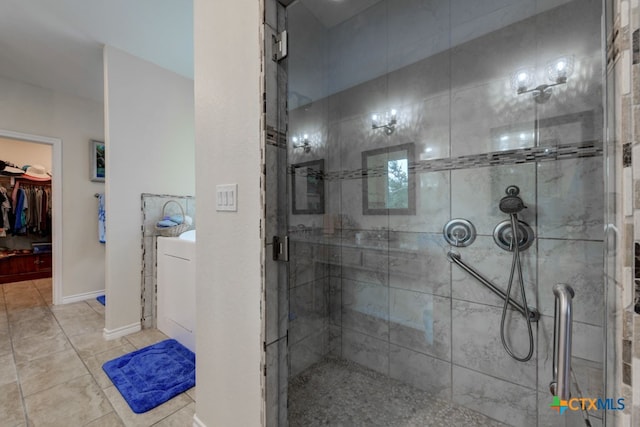 bathroom featuring tile patterned flooring and an enclosed shower