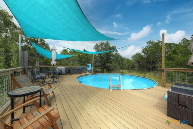 view of swimming pool featuring a wooden deck