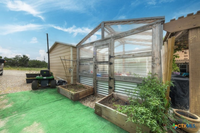 view of side of property with an outbuilding