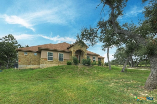 861 Rutherford, Fischer, TX 78623 - view of front of home featuring stone siding, a front lawn, and stucco siding