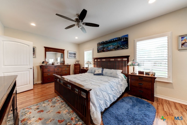 bedroom with ceiling fan and light hardwood / wood-style flooring