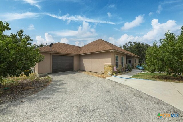 861 Rutherford, Fischer, TX 78623 - ranch-style house featuring stucco siding, asphalt driveway, and a garage