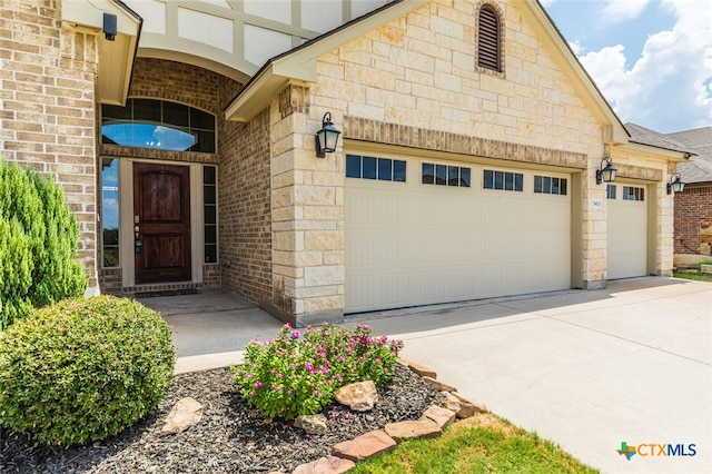 view of exterior entry with a garage