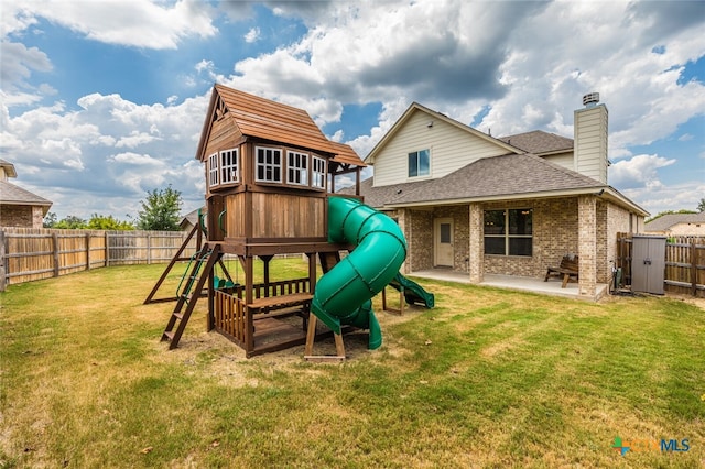 view of play area featuring a patio and a lawn