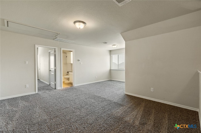 carpeted empty room featuring a textured ceiling