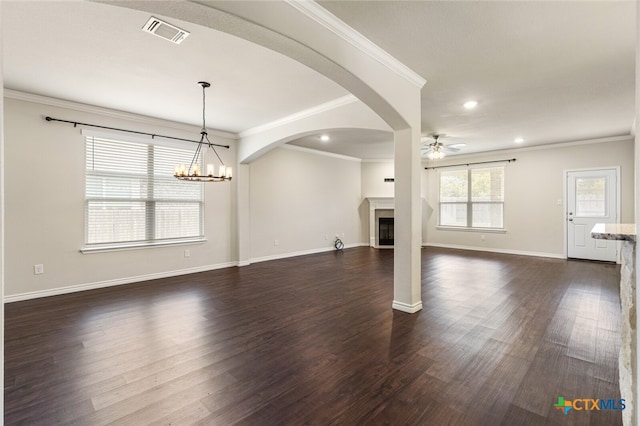 unfurnished living room with ornamental molding, dark hardwood / wood-style floors, and ceiling fan with notable chandelier