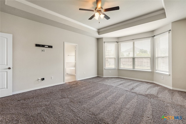 unfurnished room featuring ceiling fan, a raised ceiling, crown molding, and carpet