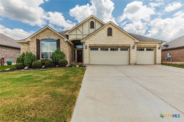 view of front of home with a front lawn and a garage