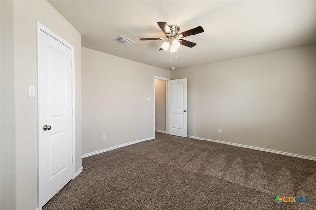 unfurnished bedroom featuring dark colored carpet and ceiling fan