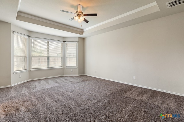 carpeted empty room featuring ceiling fan, a tray ceiling, and ornamental molding