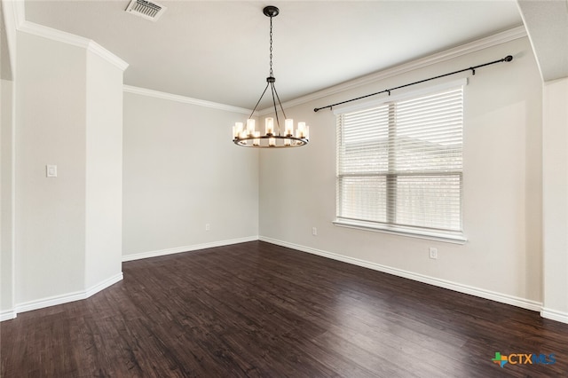 empty room featuring dark hardwood / wood-style floors, crown molding, and an inviting chandelier