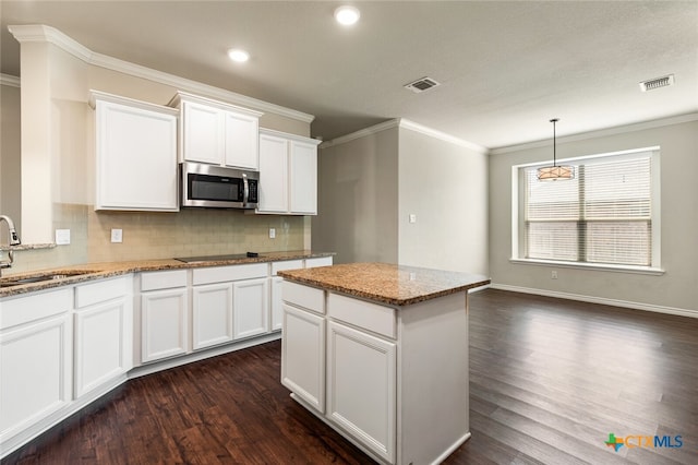 kitchen featuring white cabinets, sink, dark hardwood / wood-style floors, and light stone countertops