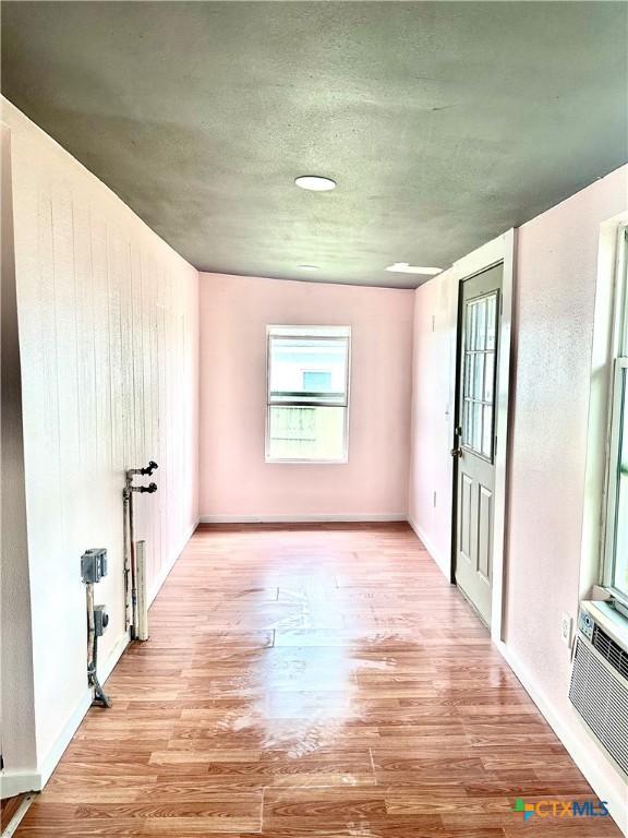 unfurnished room with baseboards and wood finished floors