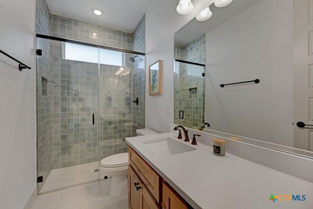 full bath featuring a stall shower, toilet, tile patterned flooring, and vanity