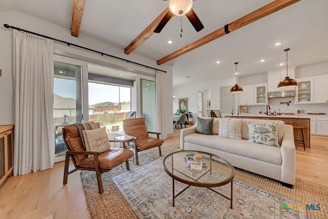 living area featuring recessed lighting, beam ceiling, light wood-style floors, and ceiling fan