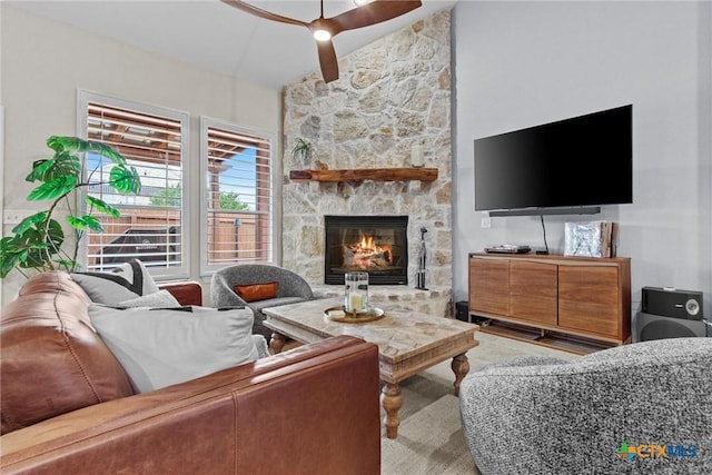 living area with lofted ceiling and a stone fireplace