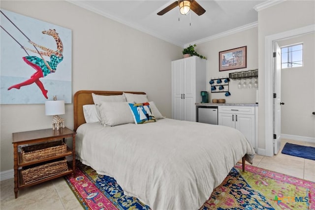 bedroom with light tile patterned floors, ornamental molding, and baseboards