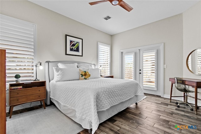 bedroom featuring ceiling fan, wood finished floors, visible vents, baseboards, and access to exterior