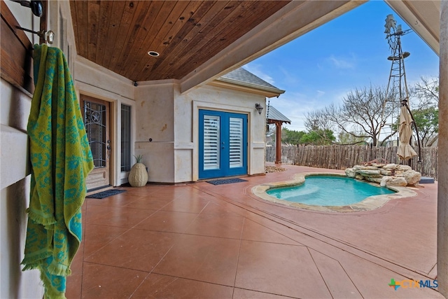 view of swimming pool with a patio, fence, and a fenced in pool