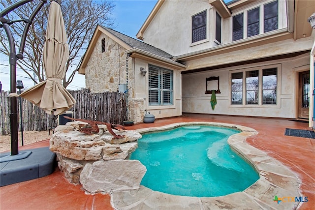 view of pool with fence and a patio