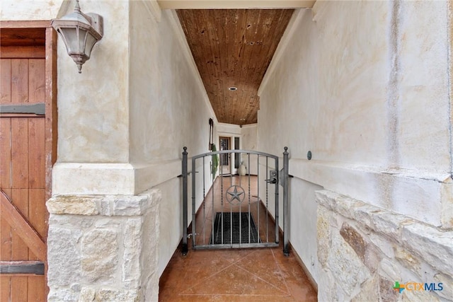 staircase featuring wooden ceiling and tile patterned floors