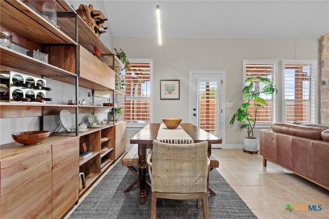 dining room featuring light tile patterned floors and baseboards