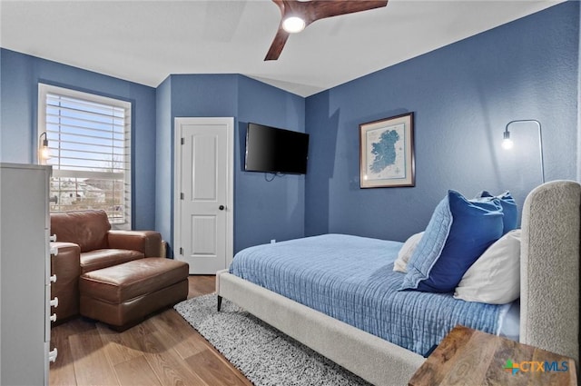 bedroom with ceiling fan and wood finished floors