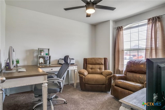 carpeted office space featuring ceiling fan