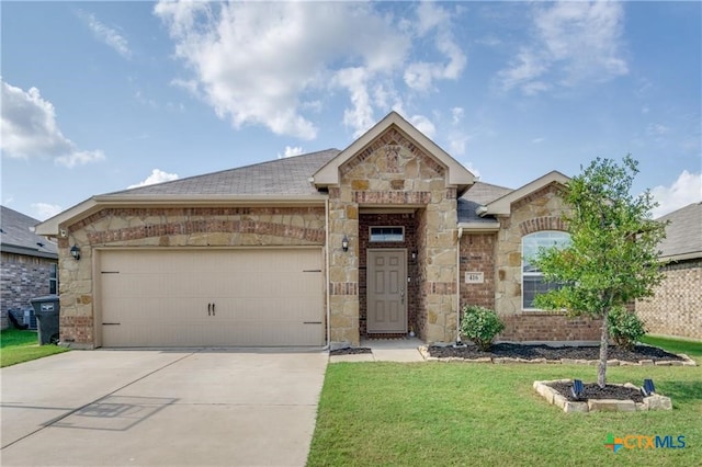 view of front of house with a garage and a front yard