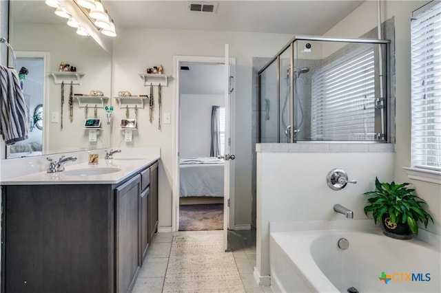 bathroom featuring vanity, plenty of natural light, tile patterned floors, and separate shower and tub