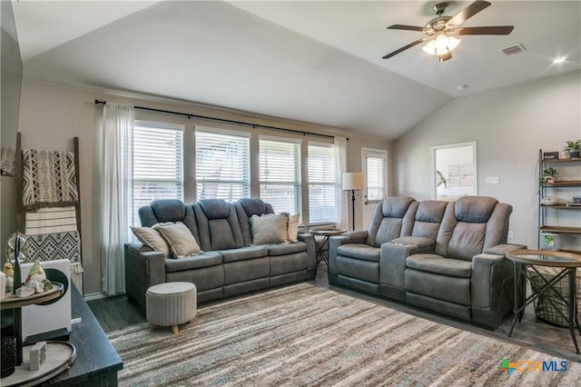 living room with dark hardwood / wood-style floors, ceiling fan, and vaulted ceiling