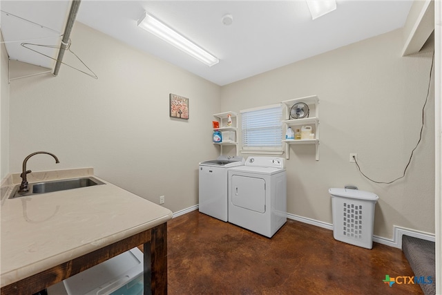 clothes washing area featuring separate washer and dryer, dark colored carpet, and sink