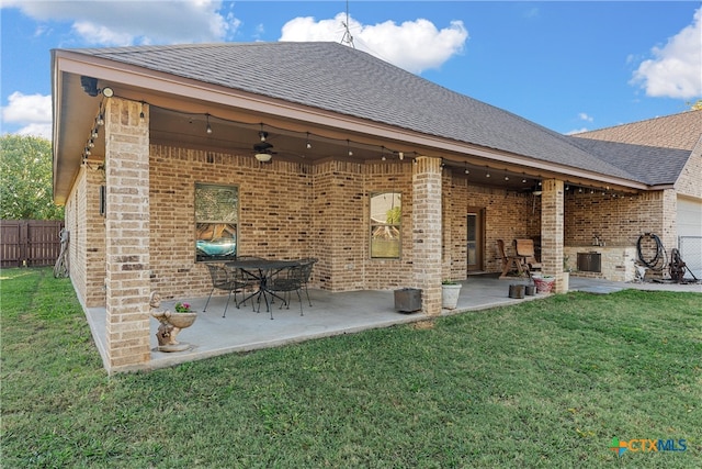 back of house with a lawn, a patio, and ceiling fan