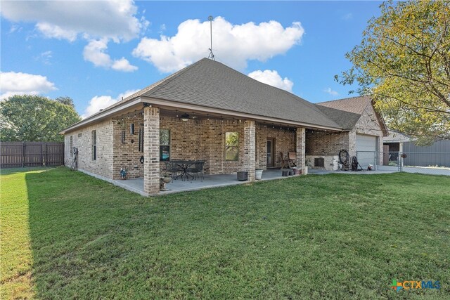 exterior space featuring a patio, a garage, and a front lawn