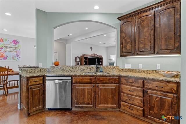 kitchen featuring kitchen peninsula, light stone countertops, sink, and dishwasher