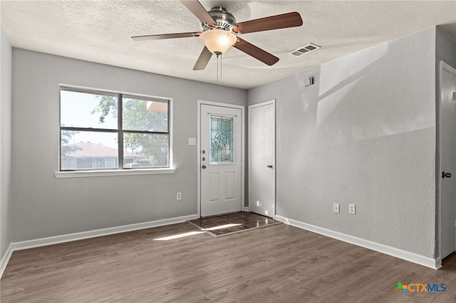 708 N 19th St, Copperas Cove, TX 76522 - entrance foyer featuring wood finished floors, a textured ceiling, and a ceiling fan