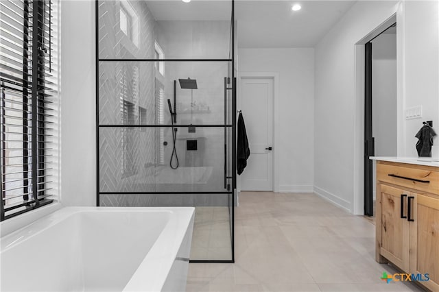 bathroom featuring shower with separate bathtub and vanity