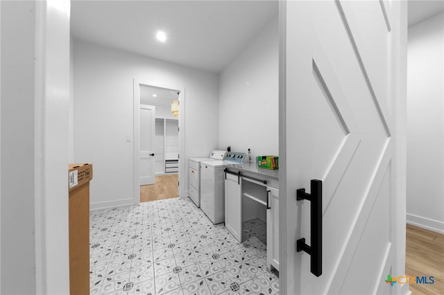 bathroom with washer and dryer and hardwood / wood-style flooring