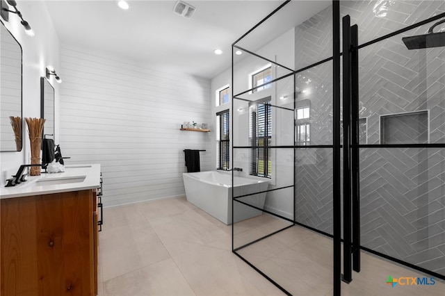 bathroom with vanity, tile patterned floors, and a bathing tub