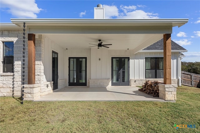 rear view of house featuring french doors, a yard, ceiling fan, and a patio area