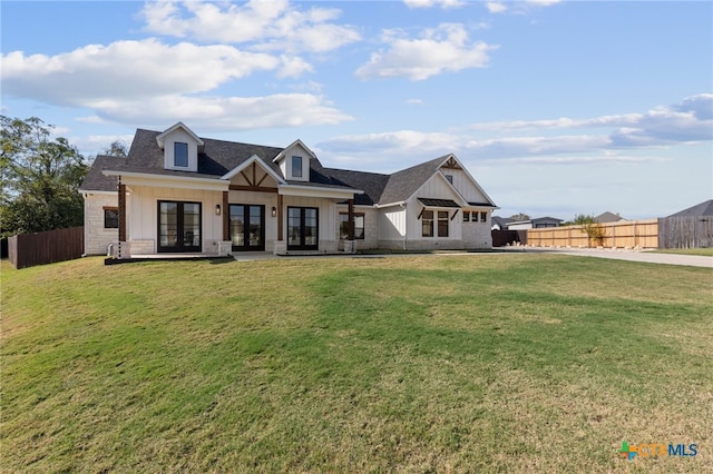 view of front of house with a front yard and french doors