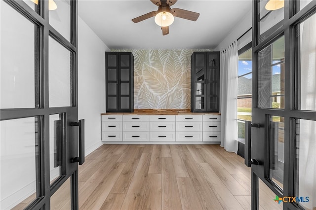 interior space with light wood-type flooring and ceiling fan