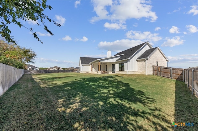 view of side of property with a lawn