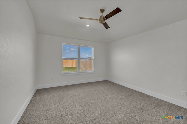 spare room with carpet flooring and ceiling fan